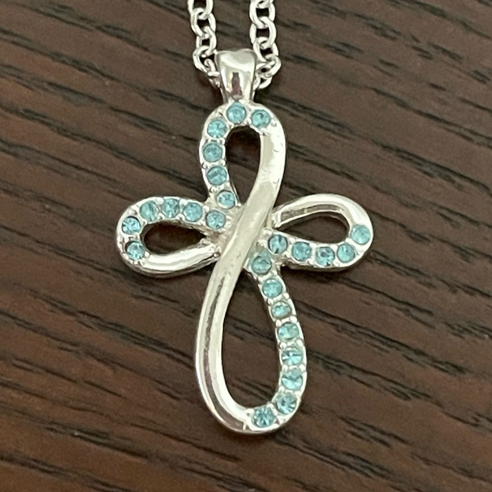 Avon blue with silver tone cross necklace. New